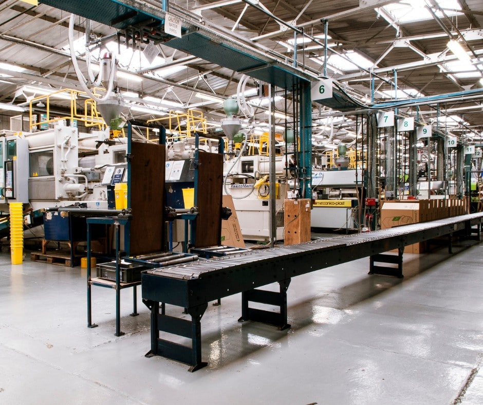 Blog - Why Reliable Electrical & Mechanical Supply Matters More Than Ever Industrial manufacturing facility with machinery and conveyor belts.