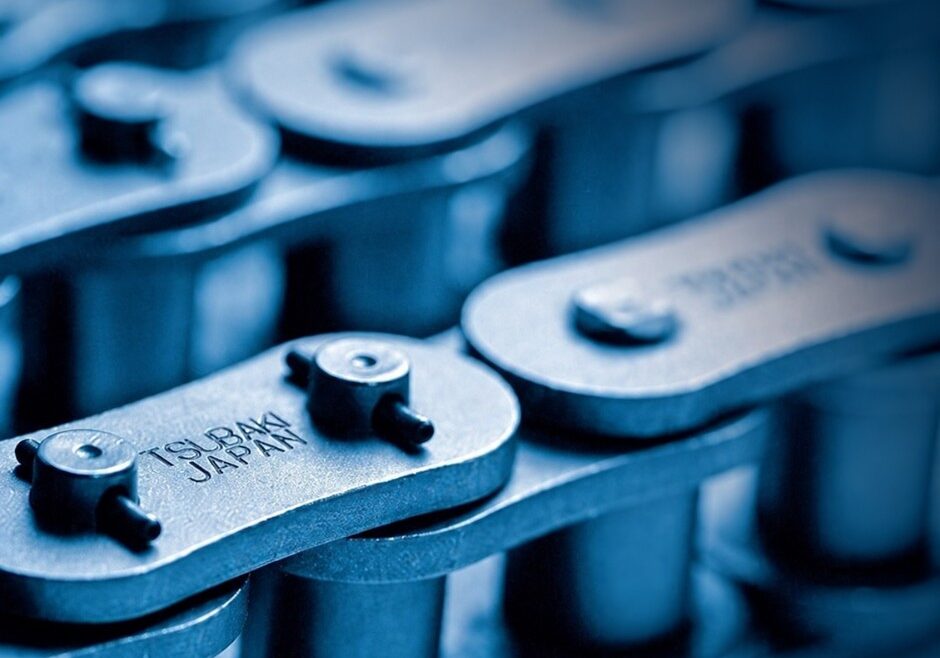 Close-up of industrial chain links with Tsubakimoto Japan branding.