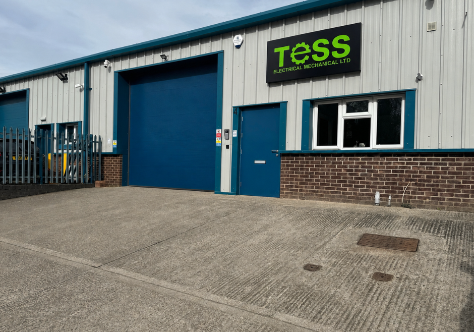 Tess Electrical Mechanical Ltd building exterior with company sign and large blue door.